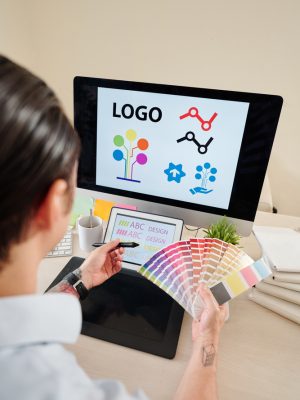Graphic,Designer,With,Color,Palette,In,Hands,Creating,Company,Logo Graphic,Designer,With,Color,Palette,In,Hands,Creating,Company,Logo